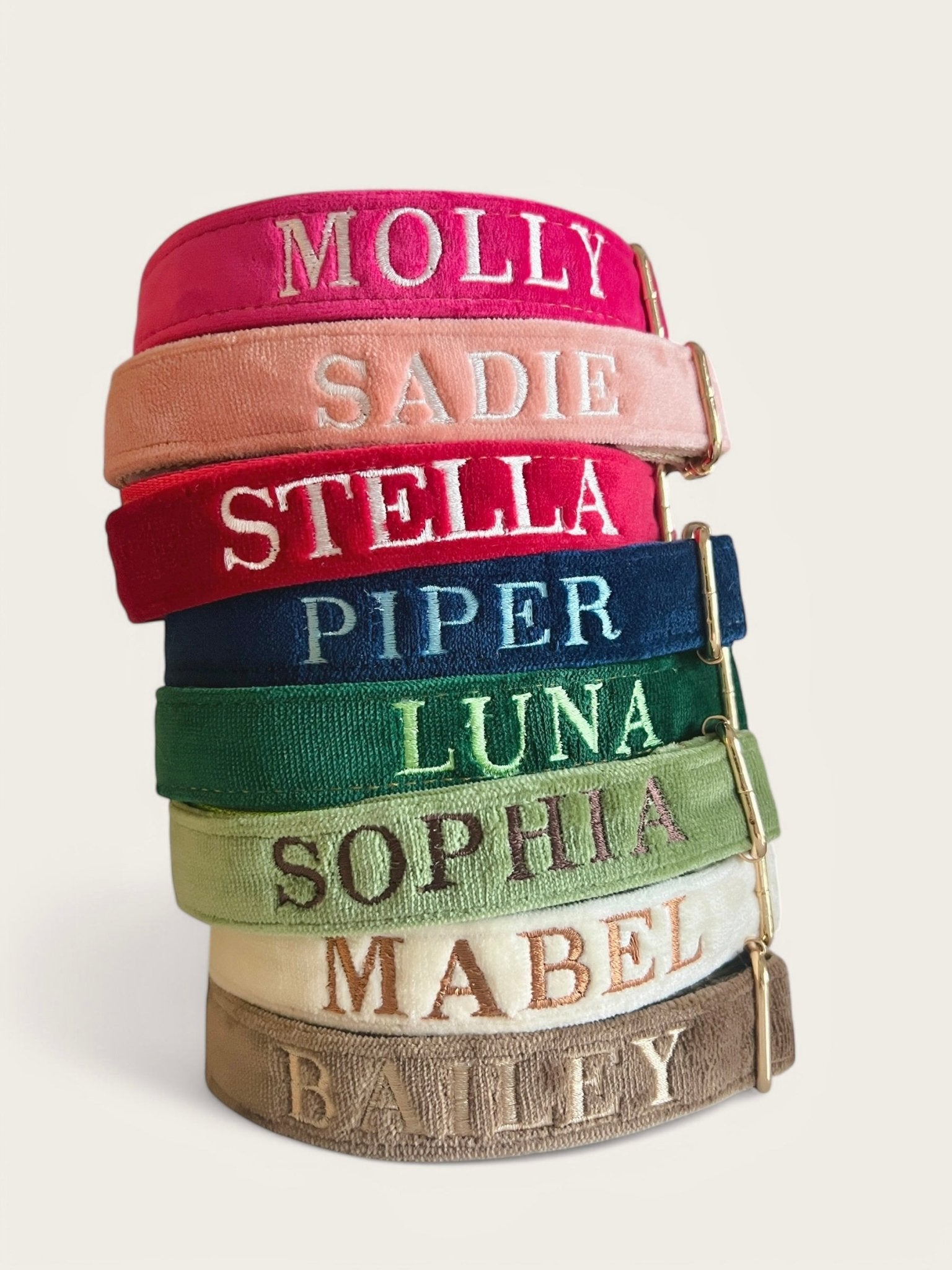 Collection of personalized embroidery dog collars in various colors with names beautifully stitched