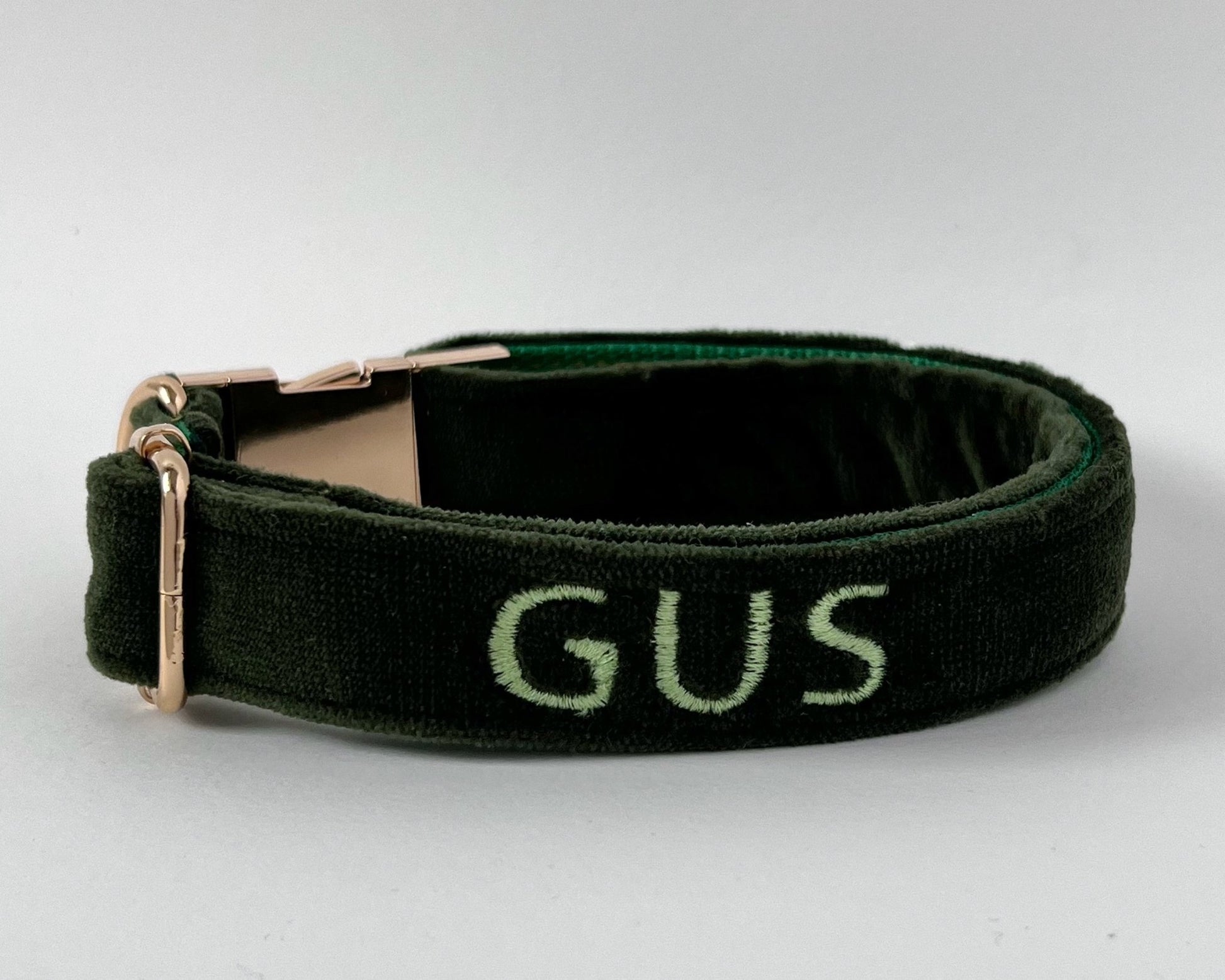 Personalized embroidery dog collars in dark green featuring the name Gus in stylish lettering