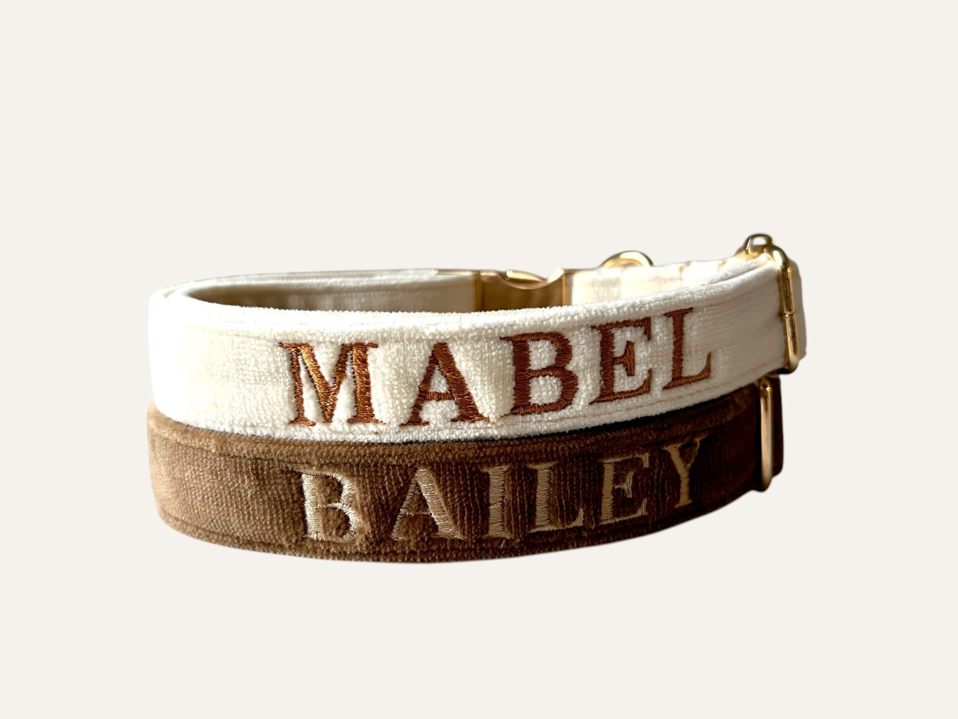 Personalized embroidery dog collars in cream and brown featuring custom names MABEL and BAILEY