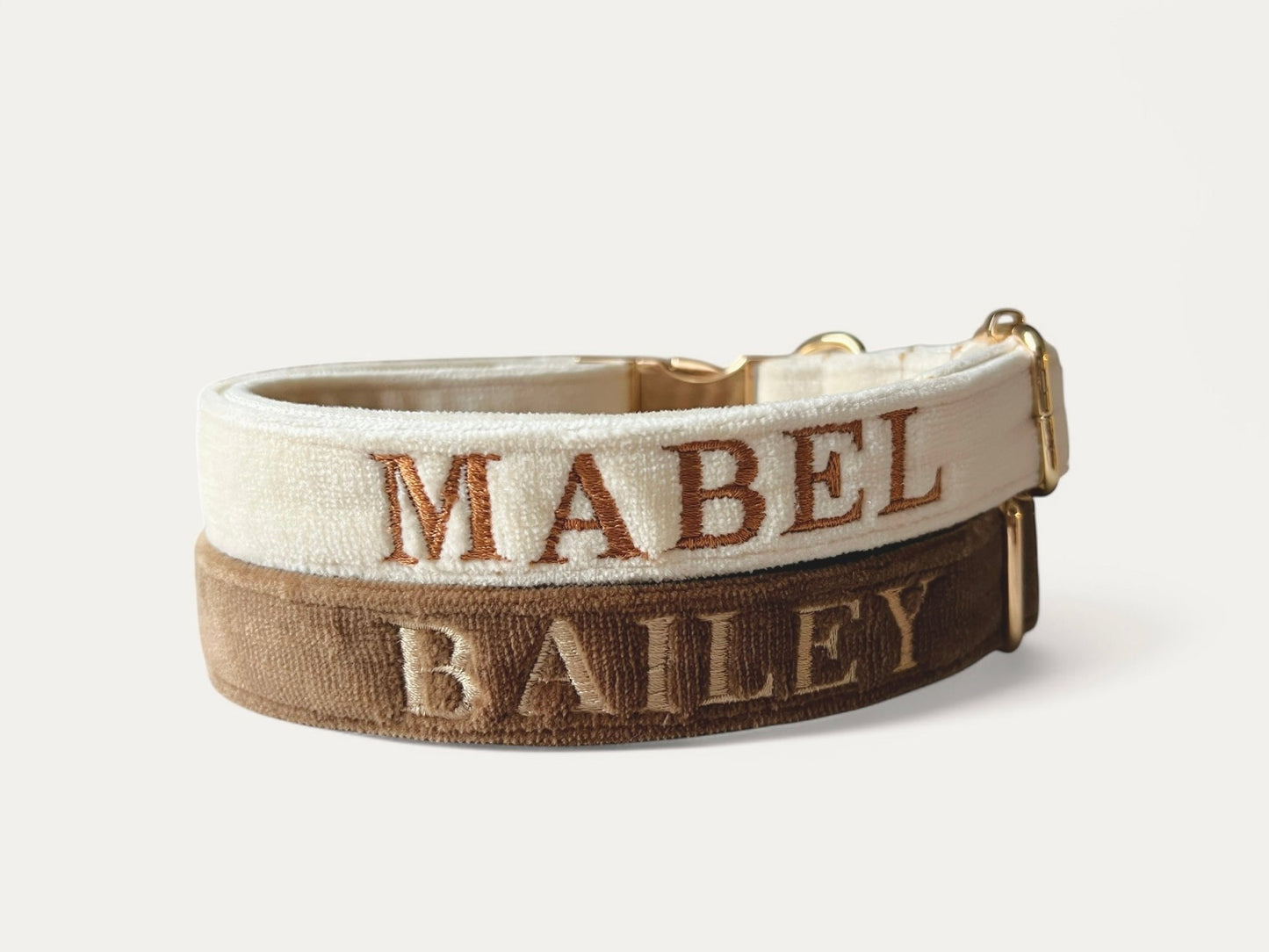 Personalized embroidery dog collars in cream and brown featuring names MABEL and BAILEY
